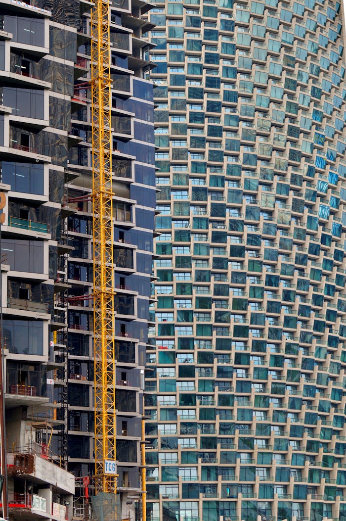 Dynamic view of contemporary skyscrapers and cranes in Dubai, showcasing modern architecture.
